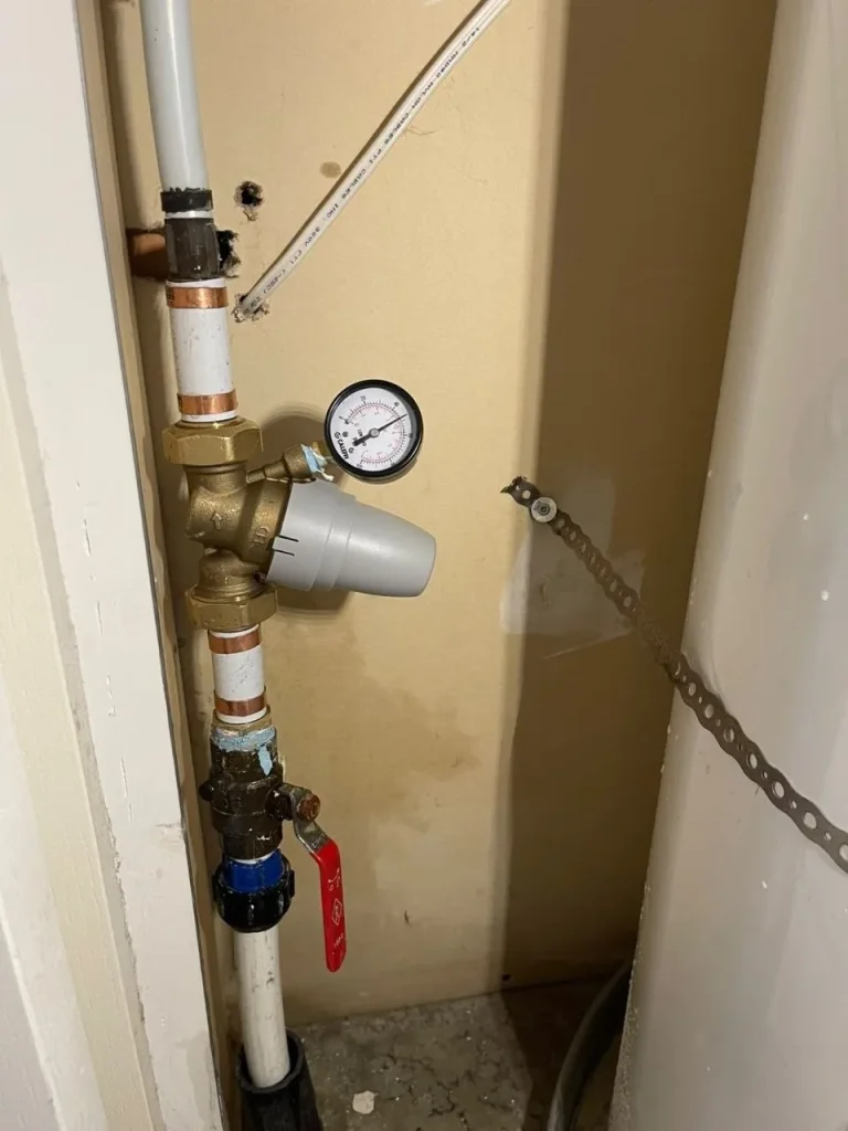 Pressure reducing valve and shutoff installed in wall cavity